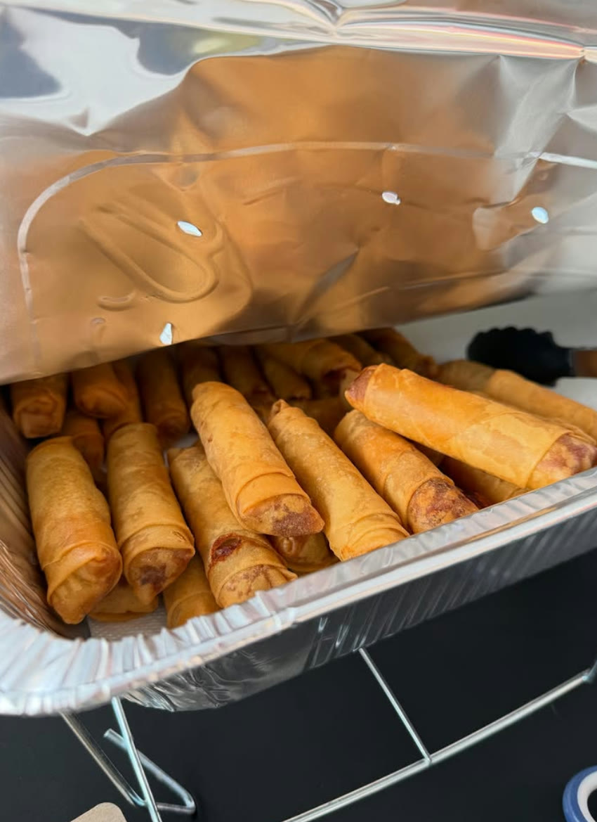 A tray of golden fried egg rolls ready to serve