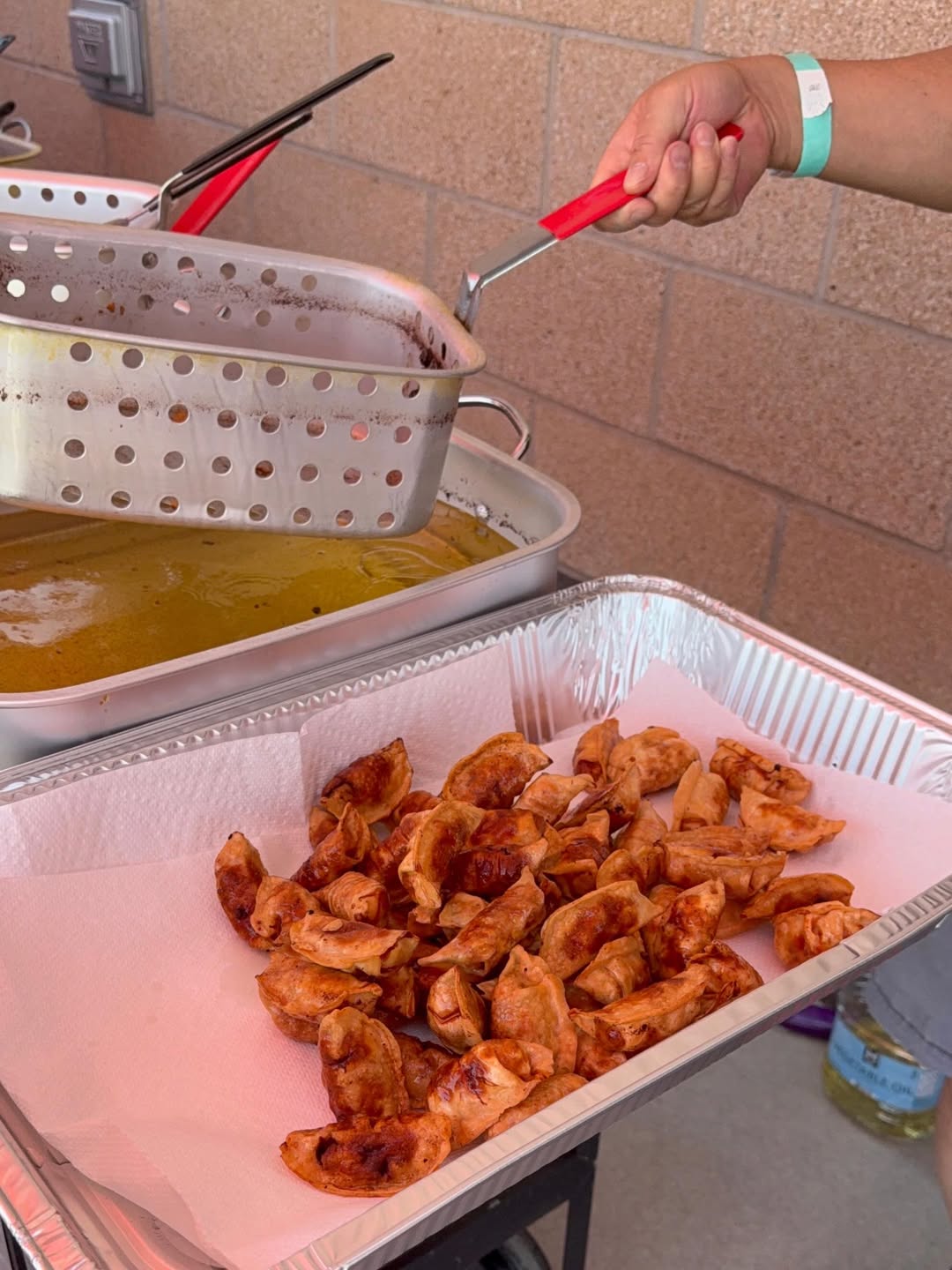 A tray of golden potstickers fresh from the fryer basket