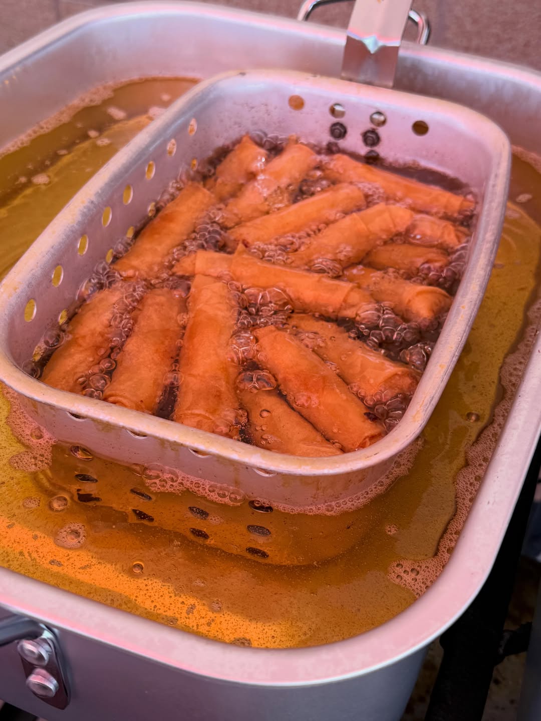 Egg rolls frying in bubbling oil at the Heavenly Delights booth